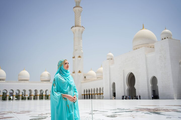 Experience the grandeur of Sheikh Zayed Grand Mosque where intricate architecture meets serene surroundings inviting travelers to immerse themselves in Abu Dhabi's rich cultural heritage.